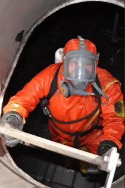 Man working in a confined space with breathing apparatus Man working in a confined space with breathing apparatus